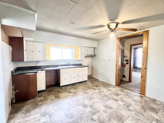 857 Byron St, Huntington, IN 46750 - kitchen with ceiling fan, stone finish flooring, dark countertops, and a sink
