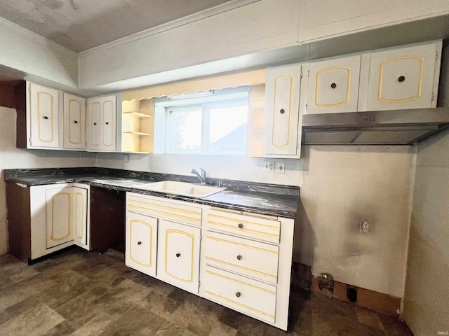857 Byron St, Huntington, IN 46750 - kitchen with a sink, dark countertops, and cream cabinets
