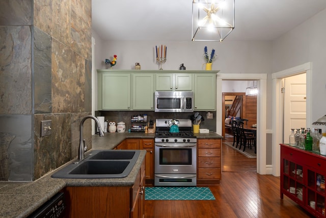 819 Columbia Ave, Fort Wayne, IN 46805 - kitchen featuring dark wood-style floors, green cabinetry, a sink, tasteful backsplash, and appliances with stainless steel finishes