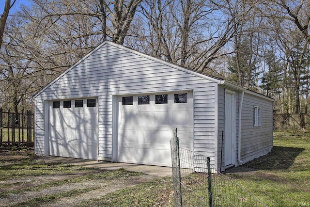 detached garage featuring fence