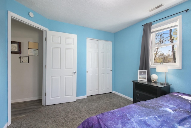 carpeted bedroom featuring a closet, visible vents, and baseboards