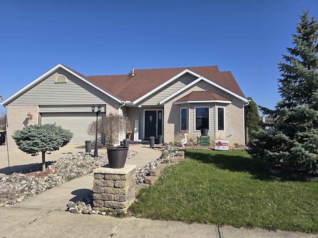 view of front of house featuring brick siding, a front yard, and a garage
