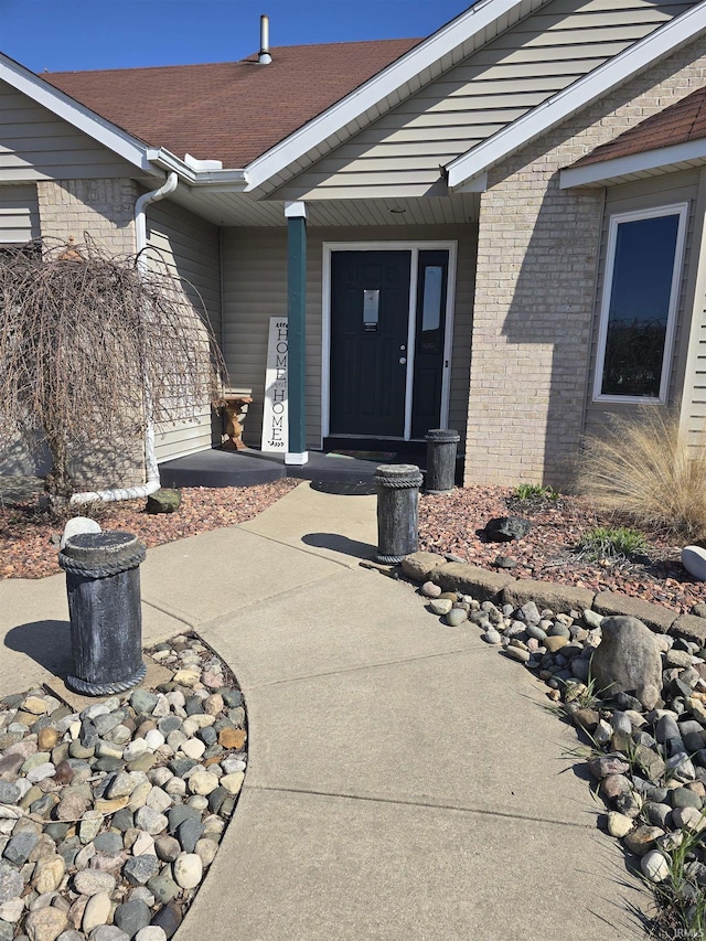 property entrance featuring brick siding