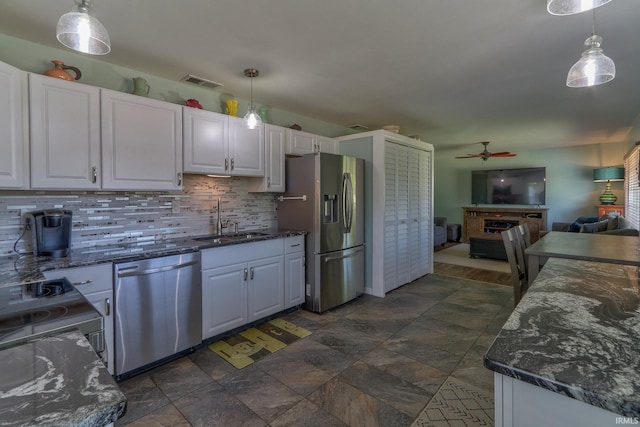 kitchen featuring ceiling fan, appliances with stainless steel finishes, a sink, and white cabinetry