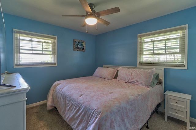 bedroom with a ceiling fan, baseboards, and carpet floors