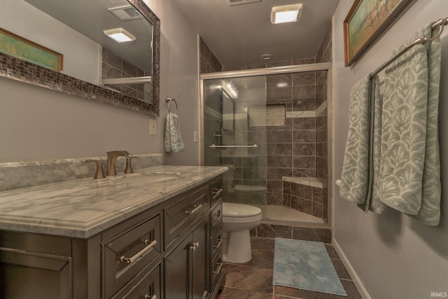 bathroom featuring a shower stall, toilet, vanity, and visible vents