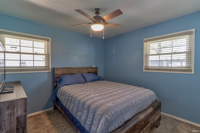 bedroom featuring carpet floors, a ceiling fan, baseboards, and multiple windows