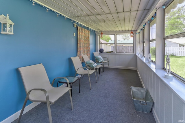 sunroom featuring track lighting