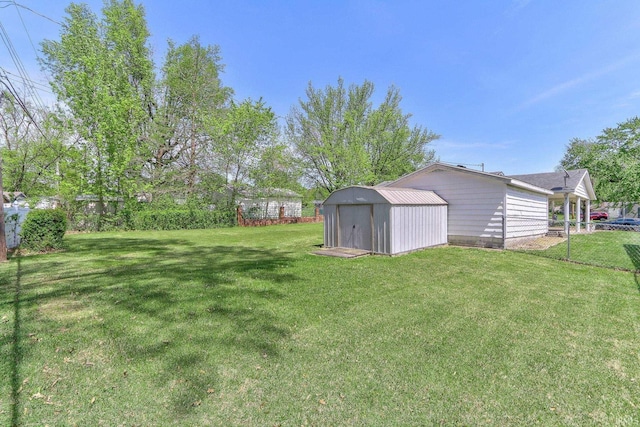 view of yard with fence, an outbuilding, and a shed