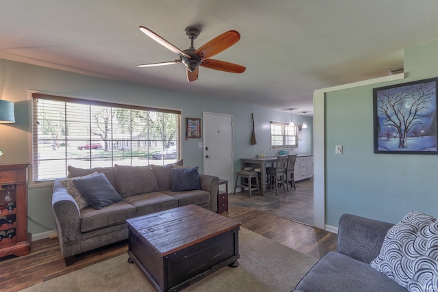 living area with wood finished floors and ceiling fan