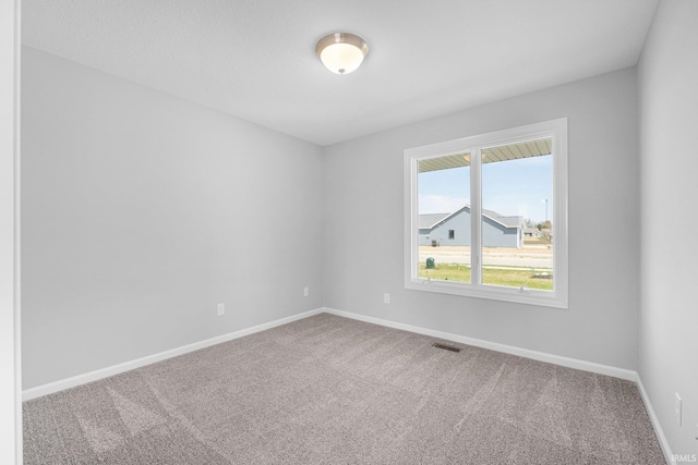 1010 Bryce Cir, Ligonier, IN 46797 - empty room featuring carpet floors, visible vents, and baseboards