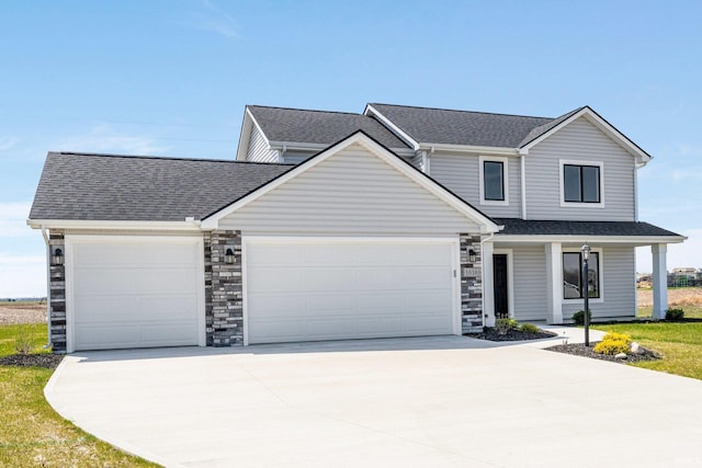 1010 Bryce Cir, Ligonier, IN 46797 - view of front facade with roof with shingles, driveway, stone siding, covered porch, and an attached garage