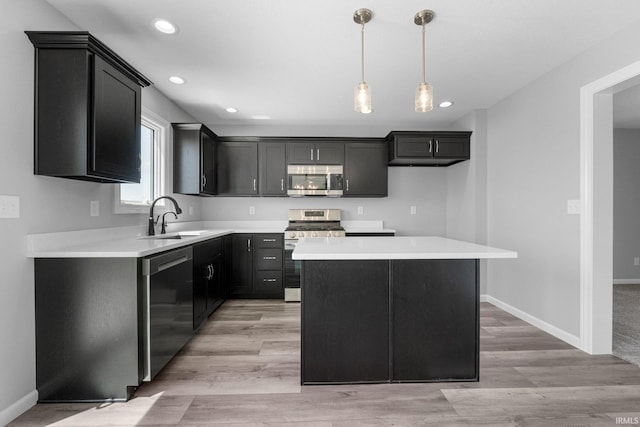 1010 Bryce Cir, Ligonier, IN 46797 - kitchen with recessed lighting, light countertops, a sink, a center island, and appliances with stainless steel finishes