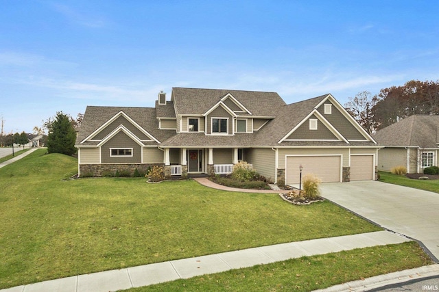 3018 Caradoza Cv, Fort Wayne, IN 46825 - craftsman-style house featuring an attached garage, a front lawn, stone siding, a porch, and concrete driveway