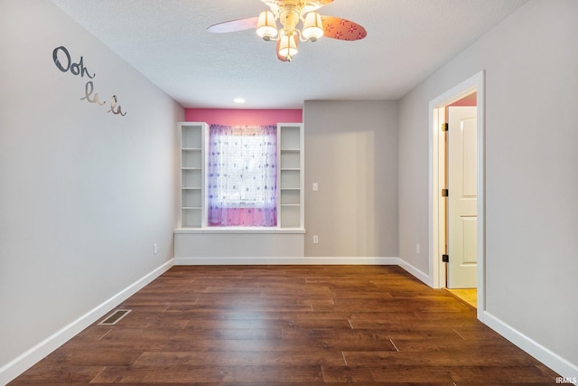 3018 Caradoza Cv, Fort Wayne, IN 46825 - empty room featuring visible vents, baseboards, ceiling fan, dark wood-style floors, and a textured ceiling