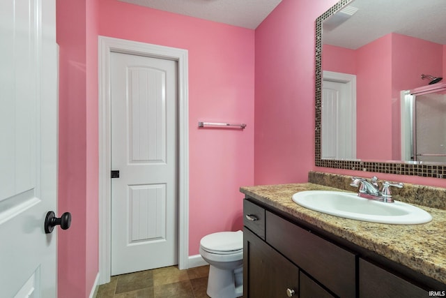 3018 Caradoza Cv, Fort Wayne, IN 46825 - full bath with a shower with door, toilet, baseboards, and vanity