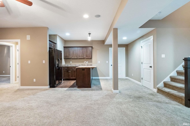 3018 Caradoza Cv, Fort Wayne, IN 46825 - kitchen with ceiling fan, light colored carpet, light countertops, open floor plan, and black fridge with ice dispenser