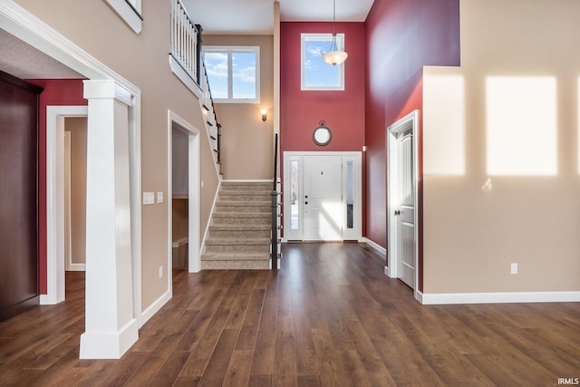 3018 Caradoza Cv, Fort Wayne, IN 46825 - foyer with decorative columns, wood finished floors, stairway, baseboards, and a high ceiling