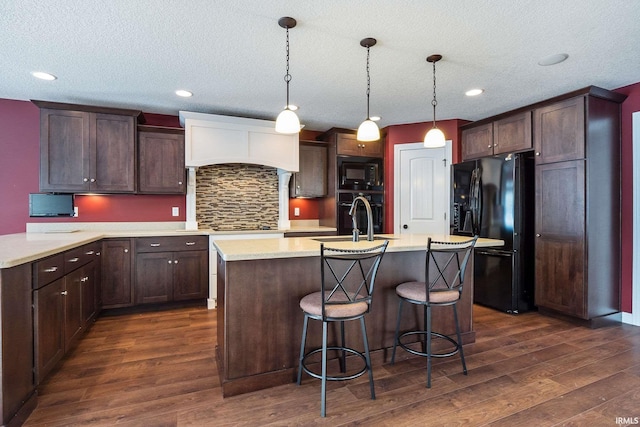 3018 Caradoza Cv, Fort Wayne, IN 46825 - kitchen with dark wood finished floors, dark brown cabinets, a sink, light countertops, and black appliances