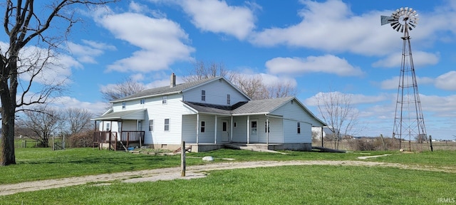 exterior space featuring a lawn, a shingled roof, and covered porch