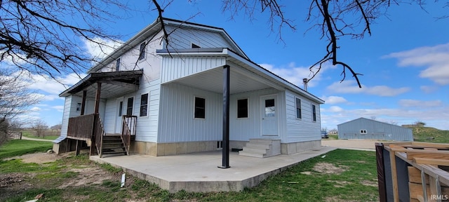 rear view of house featuring entry steps and a patio