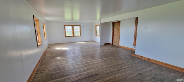 empty room featuring baseboards and wood finished floors