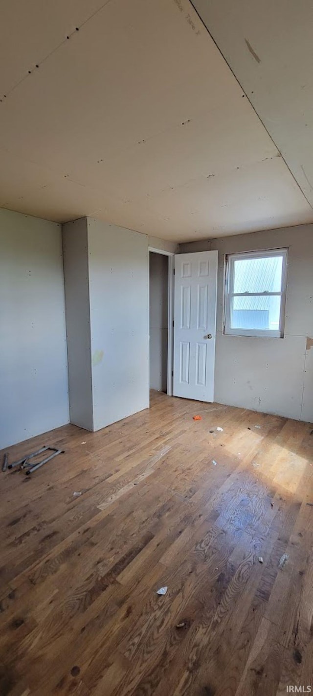 unfurnished room featuring hardwood / wood-style floors