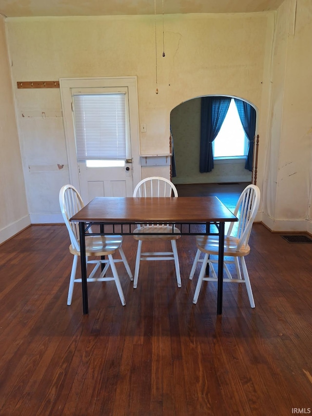 dining space with visible vents, baseboards, and wood finished floors