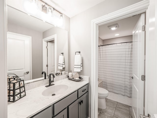 full bathroom featuring toilet, vanity, and a shower with curtain