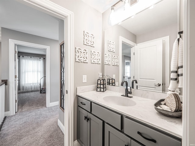 bathroom featuring baseboards and vanity