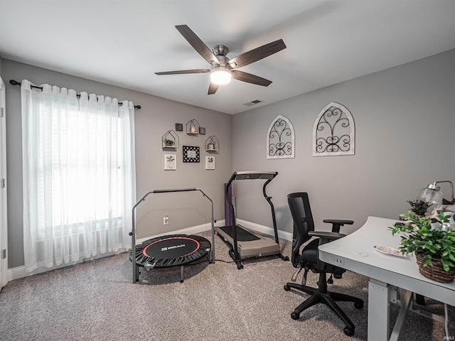 carpeted home office featuring baseboards, visible vents, and ceiling fan