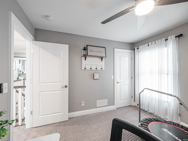 carpeted bedroom with baseboards, a ceiling fan, and visible vents