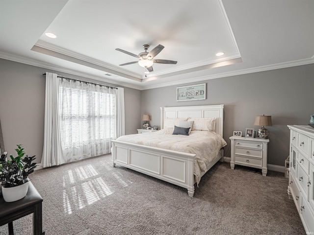 bedroom with visible vents, a tray ceiling, carpet, and ornamental molding