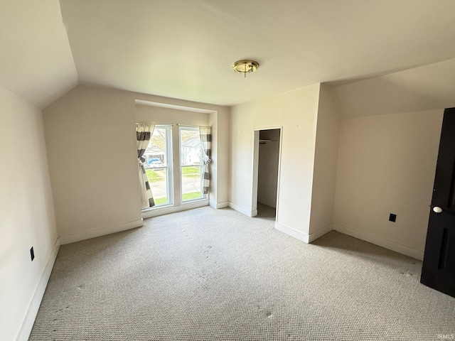 508 E Michigan St, Lagrange, IN 46761 - unfurnished bedroom featuring lofted ceiling, baseboards, a closet, and light colored carpet