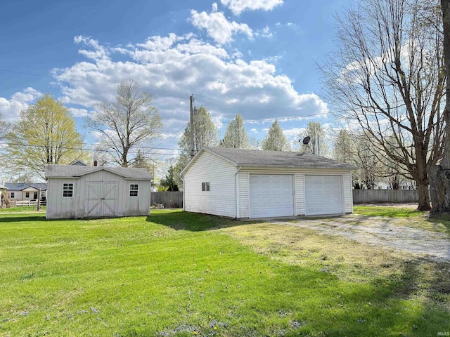 508 E Michigan St, Lagrange, IN 46761 - view of yard featuring fence, an outbuilding, and a garage