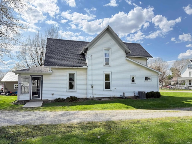 508 E Michigan St, Lagrange, IN 46761 - rear view of property with central air condition unit, a lawn, and a shingled roof