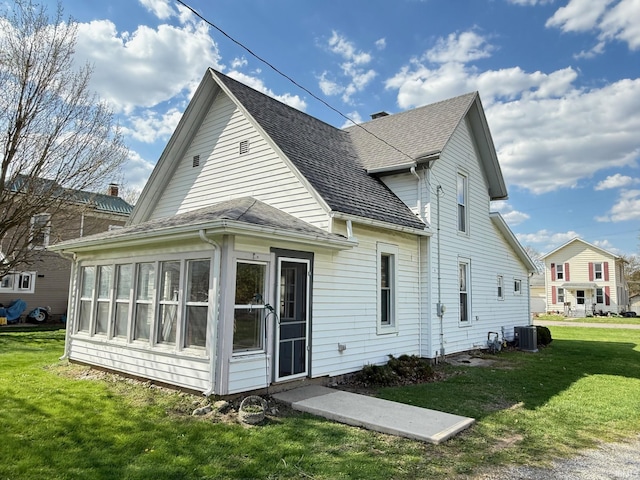 508 E Michigan St, Lagrange, IN 46761 - back of house with a sunroom, a lawn, central AC, and roof with shingles