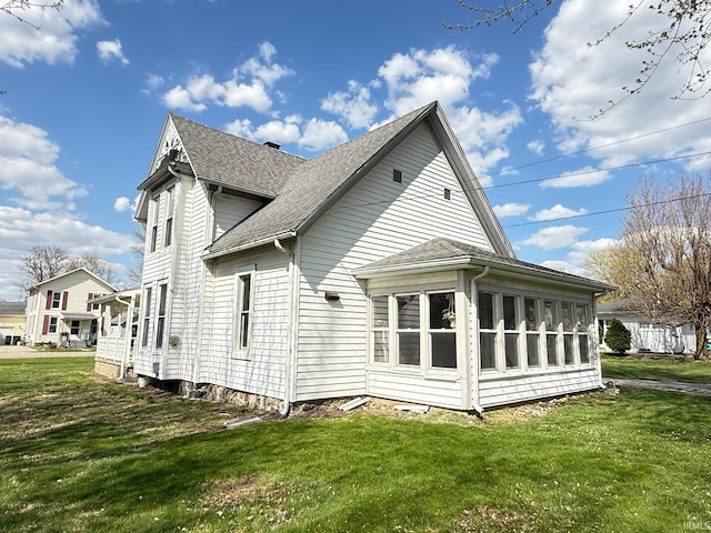 508 E Michigan St, Lagrange, IN 46761 - back of house featuring roof with shingles, a sunroom, and a lawn