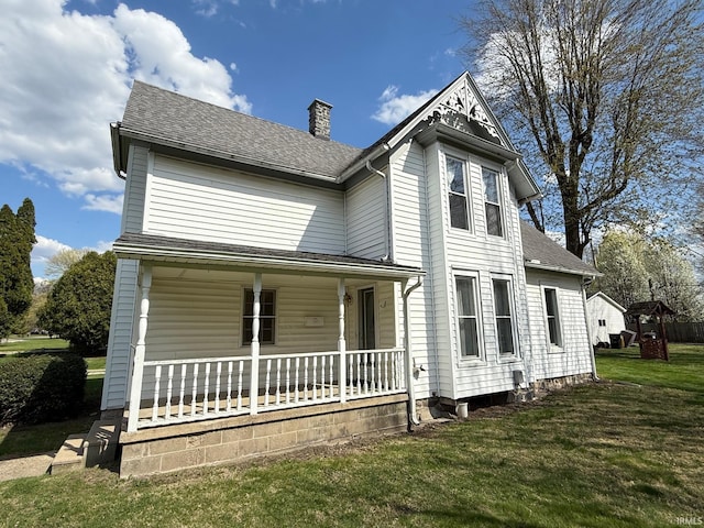 508 E Michigan St, Lagrange, IN 46761 - back of house with a porch, a lawn, a shingled roof, and a chimney