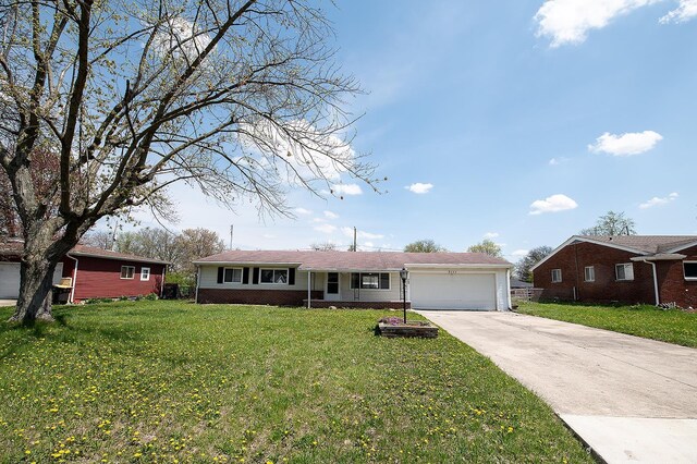ranch-style home with concrete driveway, an attached garage, brick siding, and a front lawn