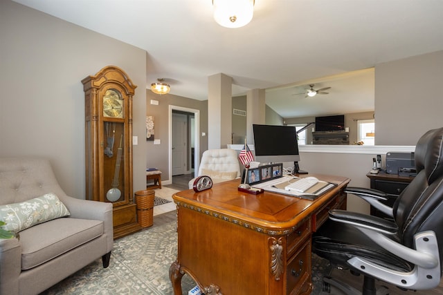 tiled office space featuring visible vents and ceiling fan