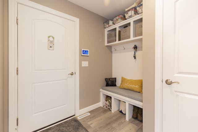 mudroom with baseboards, visible vents, and light wood finished floors