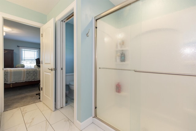 ensuite bathroom featuring marble finish floor, connected bathroom, a shower stall, and toilet