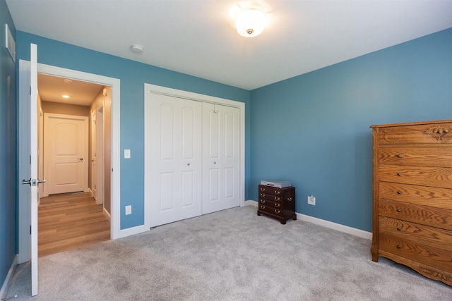 bedroom with carpet floors, a closet, and baseboards