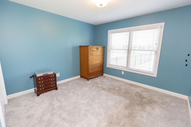 unfurnished bedroom with baseboards and carpet flooring