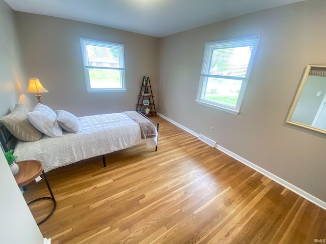 4405 Parkwood Dr, Kokomo, IN 46901 - bedroom featuring multiple windows, wood finished floors, and baseboards