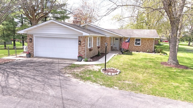 4405 Parkwood Dr, Kokomo, IN 46901 - ranch-style house featuring a garage, asphalt driveway, brick siding, and a chimney