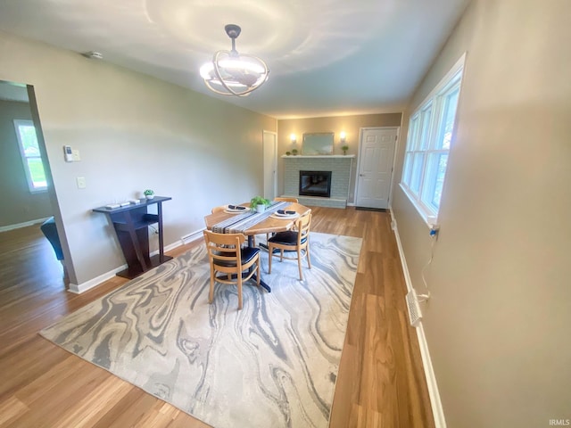 4405 Parkwood Dr, Kokomo, IN 46901 - dining area with wood finished floors, a fireplace, and plenty of natural light