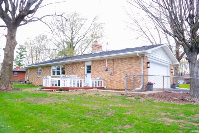 4405 Parkwood Dr, Kokomo, IN 46901 - back of property with brick siding, an attached garage, a chimney, a deck, and a yard