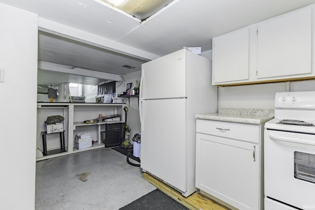 kitchen featuring white cabinets, light countertops, concrete flooring, and white appliances
